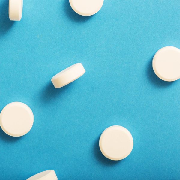 SER1 - white-round-tablet-medicine-on-blue-background-square